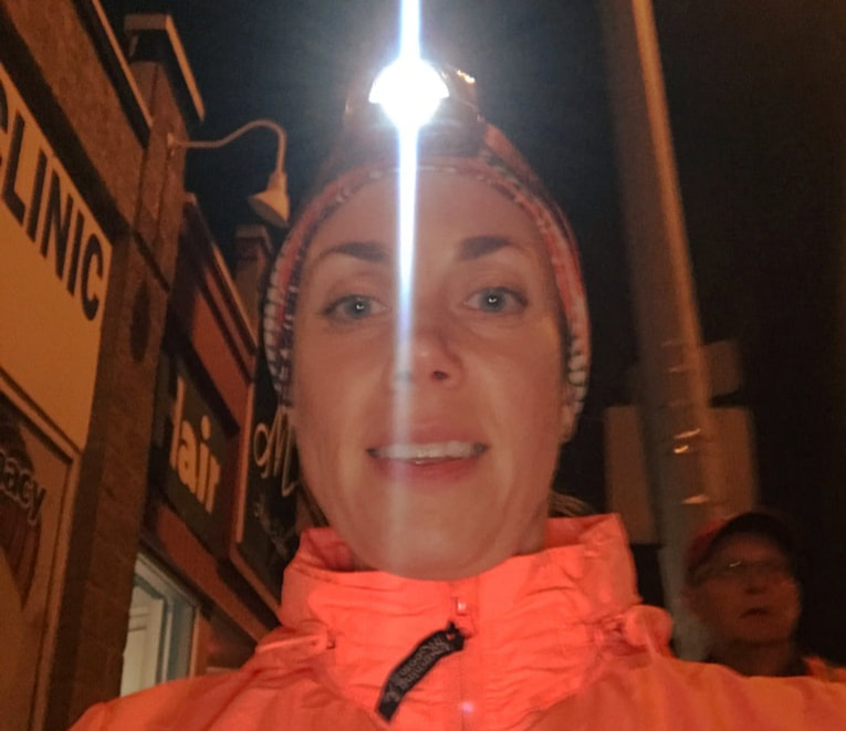 Kathy Istace the Hypothermic Runner wearing a headlamp during an evening run along 109 Street in Edmonton, Alberta