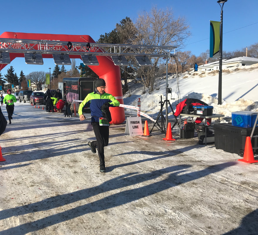 Ed Gallagher checking his watch at the finish line of the Hypothermic Half Marathon Feb 2, 2020 Edmonton, AB